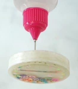 fill shaker keychain with baby oil or glycerin.