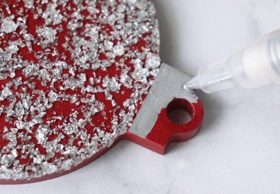 Silver paint pen coloring the top of UV Resin Foil Ornament