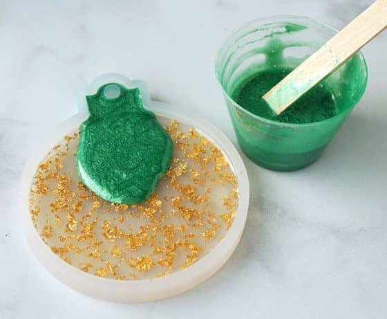 Green resin poured over gold foil resin in ornament mold